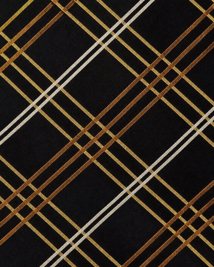 Närbild av rutigt mönster på Amalthea smal, smal slips i svart, vitt, gult och guld