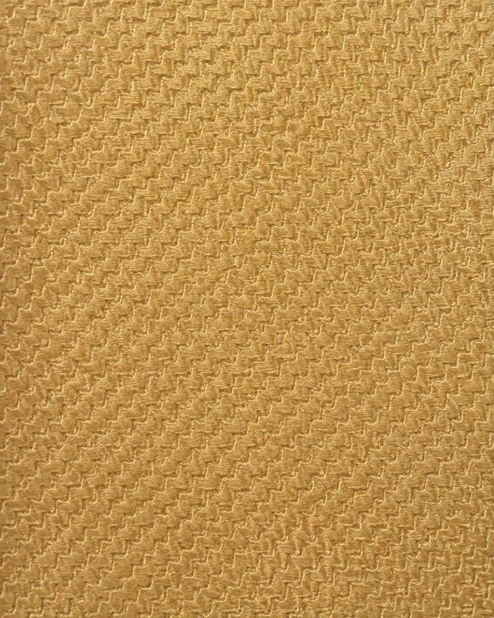 Närbild av enfärgad design på Aureum, bröstnäsduk i gult och guld