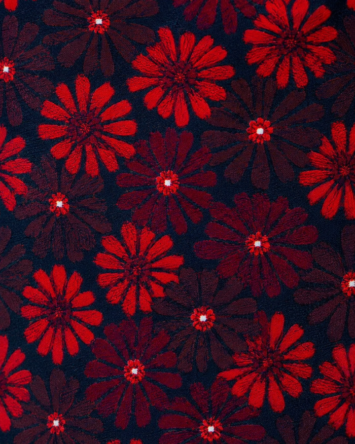Närbild av blommigt motiv på ERRIAPO SMAL, smal slips i rött