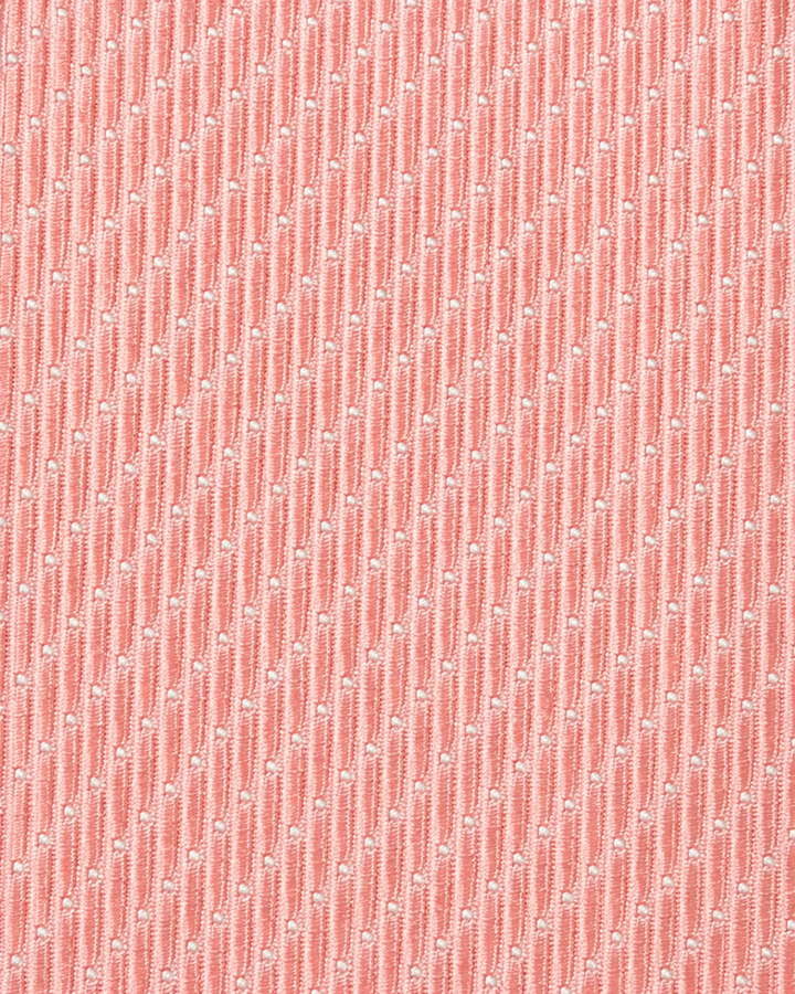 Närbild av prickigt mönster på SVERKER SMAL, smal slips i rosa och vitt